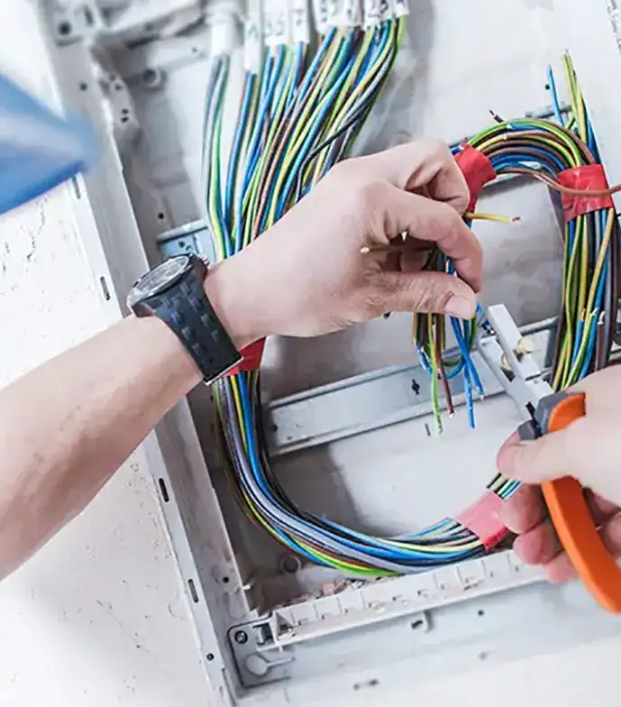 A person working on an electrical panel