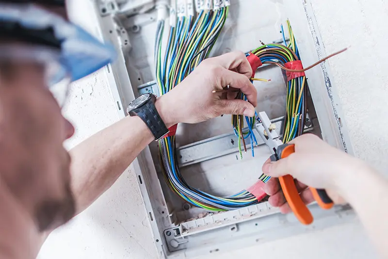 A person working on an electrical panel