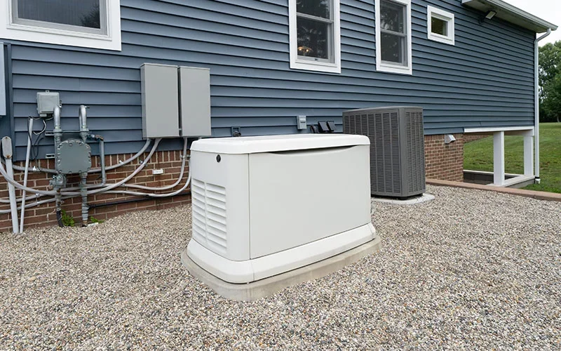 A home's exterior with a large, light-colored generator unit