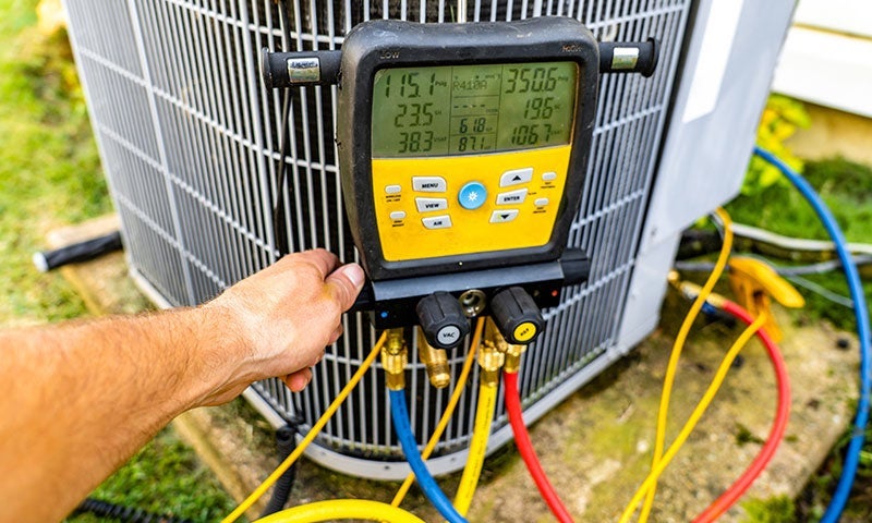 An outdoor AC Unit being diagnosed